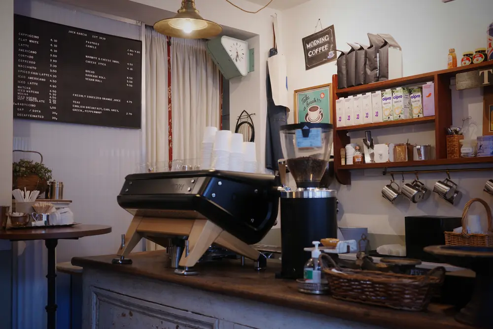 The counter with espresso machine, menu board and pendant lamp