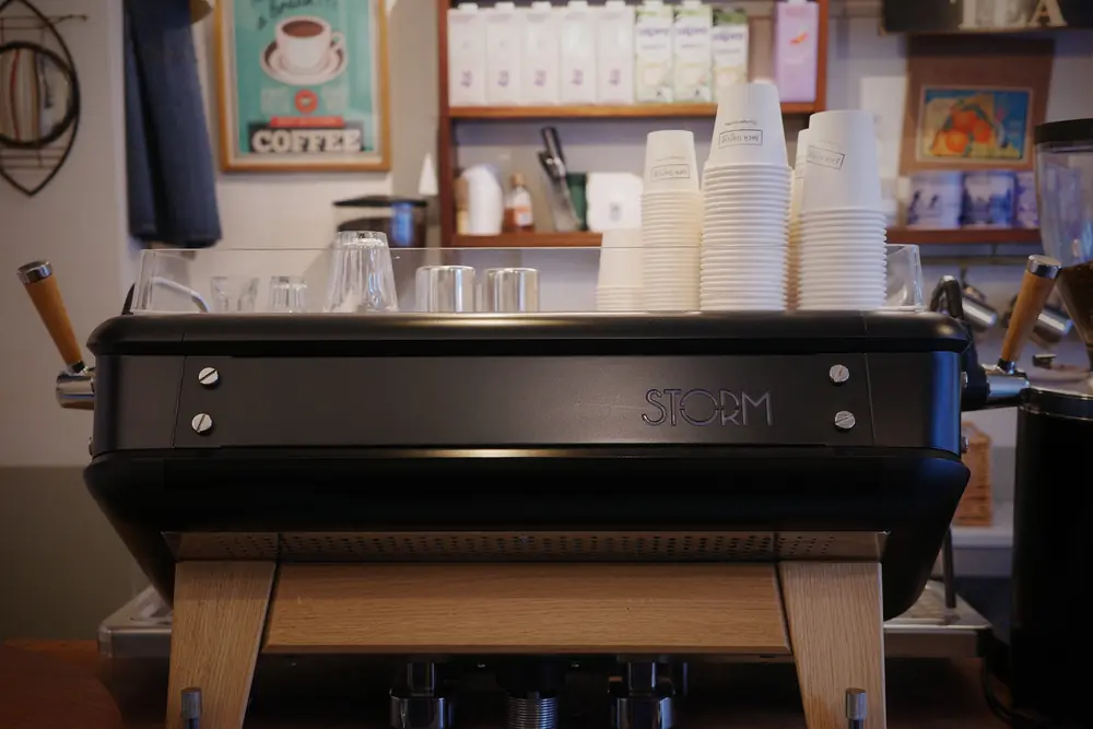Close-up of the espresso machine with stacked cups