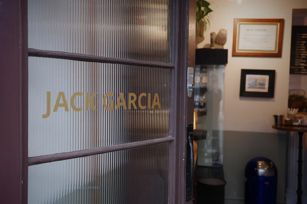 Reeded glass door with Jack Garcia lettering